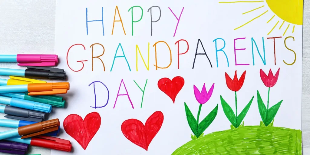 A featured image for happy national grandparents day showing the sun hearts and flowers.